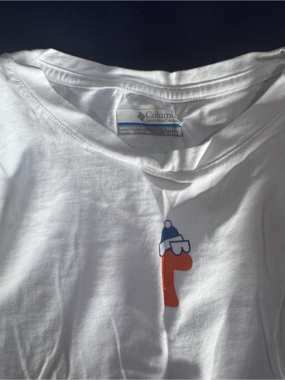 Columbia White Tee with Orange Letter and Blue Dino Hat Graphic